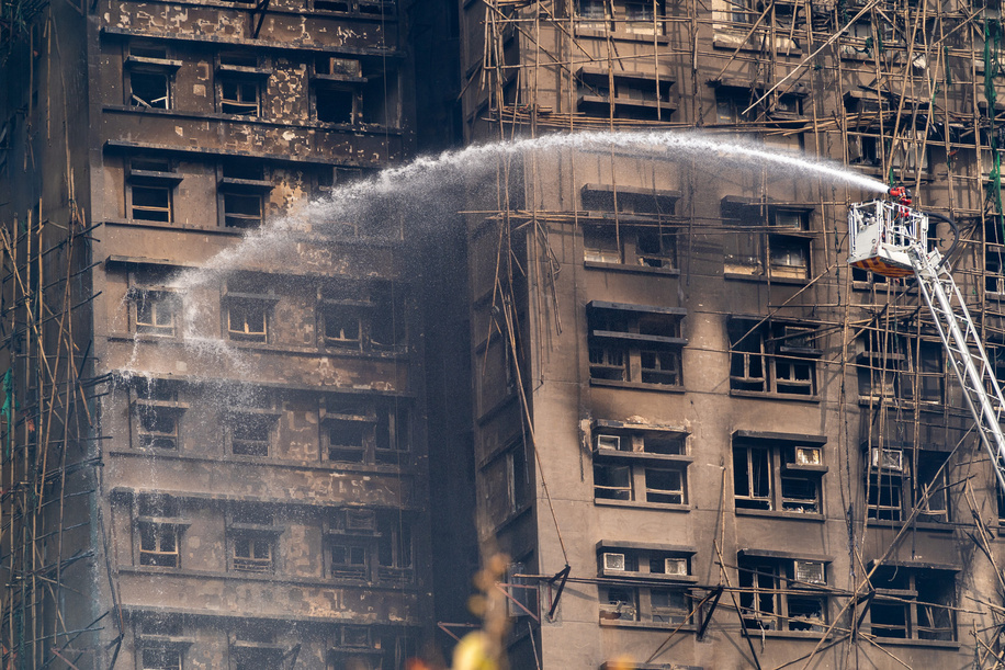 Firefighters spray water on flames as a major fire burns through several apartment blocks at the Wang Fuk Court residential estate. Residential buildings continue to burn at Wang Fuk Court in the Tai Po district of Hong Kong. At least 50 people are confirmed dead and hundreds are still missing following a high-rise apartment fire at Wang Fuk Court in Tai Po district which was started on Wednesday afternoon.