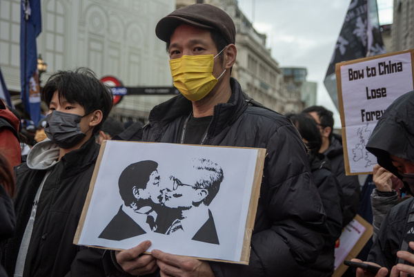 A protester holds a sign with an image of Keir Starmer (R) and Xi Jinping (L) kissing on it during the demonstration on Piccadilly Circus. Hong Kongers, Taiwanese, and Tibetans staged a protest at Piccadilly Circus against the planned Chinese mega-embassy, which is proposed to be built at Royal Mint Court near Tower Bridge.