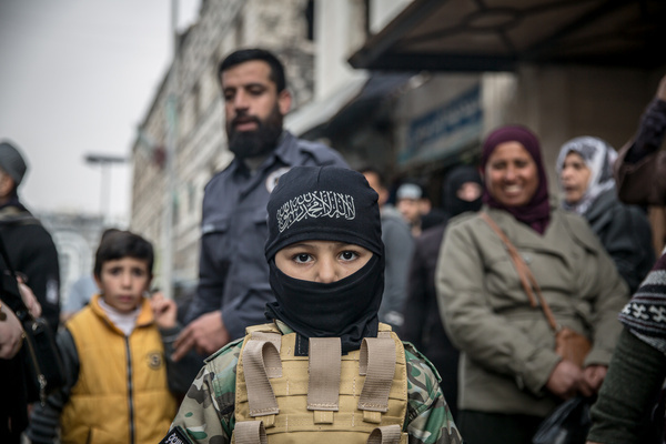 A Syrian child dressed up as a rebel fighter. People gathered in Homs to celebrate the first anniversary of the fall of Bashar al-Assad’s regime, marking one year since its collapse on December 8, 2024. The new government has taken steps that improved daily life for many Syrians, such as closing notorious prisons, increasing electricity supply, and raising civil service salaries, fueling a sense of hope after years of oppression and war. However, the post-Assad transition remains fraught with challenges—including sectarian tensions, fragile security, and concerns over concentrated political power—highlighting the difficult road ahead for rebuilding Syria.