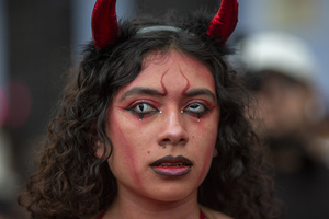 A woman dressed as a devil seen during the Burning of the Devil on the eve of the celebration of the Virgin of the Immaculate Conception, festivities that mark the beginning of Christmas in Guatemala.