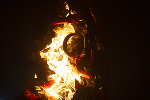 The fire consumes the paper figure known as "The Three Wise Devils" during the Burning of the Devil on the eve of the celebration of the Virgin of the Immaculate Conception, festivities that mark the beginning of Christmas in Guatemala.