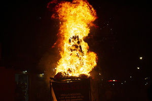 The fire consumes the paper figure known as "The Three Wise Devils" during the Burning of the Devil on the eve of the celebration of the Virgin of the Immaculate Conception, festivities that mark the beginning of Christmas in Guatemala.