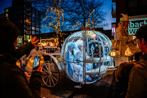 People are seen cheering the magical winter carriage. The Winter Wonder Parade marks the festive opening of the annual Nijmegen Winter Weeks. This enchanting spectacle features a fairytale procession including a winter carriage pulled by white horses, ice queens on stilts, musicians, dancers, and jugglers. The parade departs from the Lindenberg at 4:30 PM and concludes at the Grote Markt, where the Christmas tree lighting officially starts three weeks of winter magic.