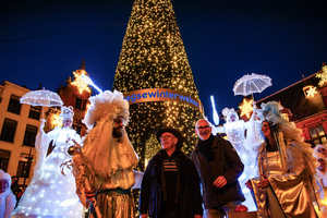 Nijmegen Alderman John Brom (the one with the hat) is smiling after turning on the Christmas tree lights. The Winter Wonder Parade marks the festive opening of the annual Nijmegen Winter Weeks. This enchanting spectacle features a fairytale procession including a winter carriage pulled by white horses, ice queens on stilts, musicians, dancers, and jugglers. The parade departs from the Lindenberg at 4:30 PM and concludes at the Grote Markt, where the Christmas tree lighting officially starts three weeks of winter magic.