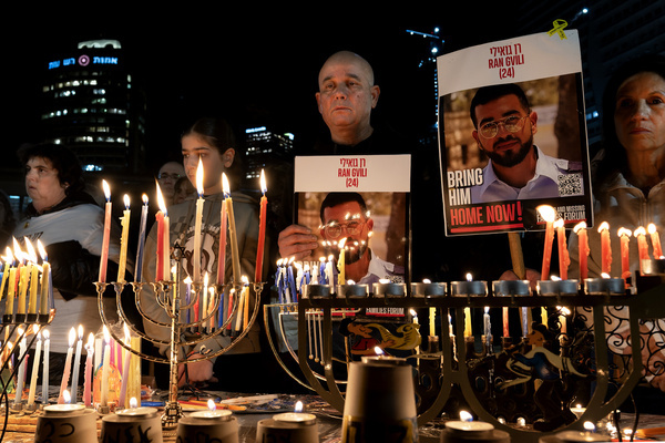 Many people attend the final Hanukkah candle-lighting ceremony at Hostages Square, carrying photos of the last fallen hostage still held by Hamas. The eighth and final Hanukkah candle was lit at Hostages Square in a ceremony calling for the return of the last fallen hostage, Ran Goyali, still held by Hamas. The event was attended by his family and by the families of former hostages who have returned to Israel.