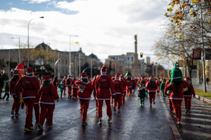 Hundreds of people run through the center of Madrid during a charity race. A charity race was organized by the Spanish department store chain El Corte Ingles where participants, mostly families, run dressed as Santa Claus or in Christmas-themed costumes.