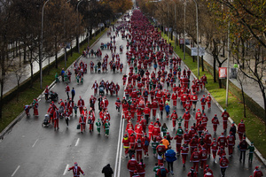 Hundreds of people run through the center of Madrid during a charity race. A charity race was organized by the Spanish department store chain El Corte Ingles where participants, mostly families, run dressed as Santa Claus or in Christmas-themed costumes.