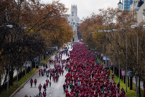 Hundreds of people run through the center of Madrid during a charity race. A charity race was organized by the Spanish department store chain El Corte Ingles where participants, mostly families, run dressed as Santa Claus or in Christmas-themed costumes.