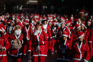 Hundreds of people run through the center of Madrid during a charity race. A charity race was organized by the Spanish department store chain El Corte Ingles where participants, mostly families, run dressed as Santa Claus or in Christmas-themed costumes.