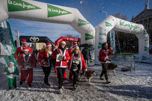 A group of participants in a charity race reach the finish line. A charity race was organized by the Spanish department store chain El Corte Ingles where participants, mostly families, run dressed as Santa Claus or in Christmas-themed costumes.