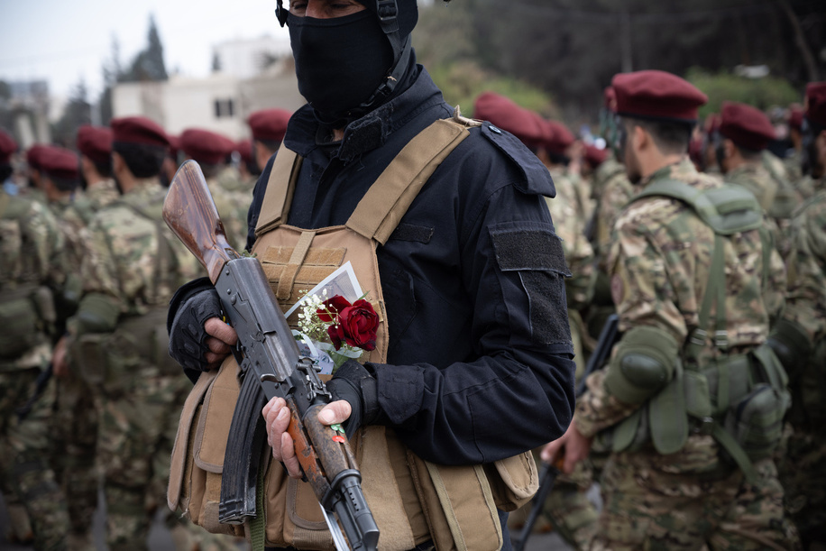 Armed security personnel on the streets as Syrian transitional government stages a military parade at Umayyad Square as part of the Liberation Day anniversary. Syrians crowd the streets of central Damascus, waving flags and singing patriotic songs amid fireworks, flares, and car horns as they celebrate the first anniversary of the fall of the Assad regime.
