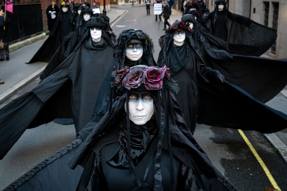 Oil Slickers seen posing during the protest. Extinction Rebellion Oil Slickers staged a symbolic performance protest in Whitehall moving in formation and stopping at Parliament Square, the Ministry of Defence, and 55 Tufton Street to highlight what they describe as government failure to meet climate commitments. They carried banners reading “Tell the Truth”, “A Better World Is Possible” and “1.5°C Is Dead”.