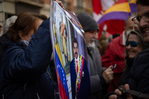 A protester carries a portrait of Nicolás Maduro. During a rally organized by leftist groups in front of the US Embassy in Madrid to condemn the attacks carried out by the United States in Caracas in the early hours of January 3rd and the illegal arrest of President Nicolás Maduro and his transfer to a prison in New York along with his wife.