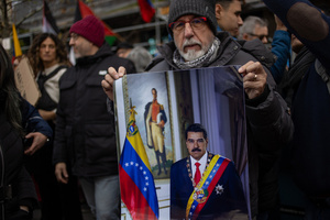 A protester carries a portrait of Nicolás Maduro. During a rally organized by leftist groups in front of the US Embassy in Madrid to condemn the attacks carried out by the United States in Caracas in the early hours of January 3rd and the illegal arrest of President Nicolás Maduro and his transfer to a prison in New York along with his wife.
