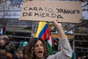 Protesters carry signs against the US and Donald Trump. During a rally organized by leftist groups in front of the US Embassy in Madrid to condemn the attacks carried out by the United States in Caracas in the early hours of January 3rd and the illegal arrest of President Nicolás Maduro and his transfer to a prison in New York along with his wife.
