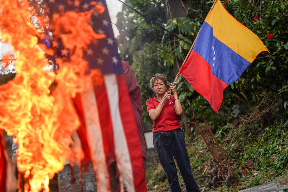 Demonstrators burn flags during a protest in support of the Venezuelan president Nicolás Maduro, following reports of his apprehension by U.S. military forces in Caracas.