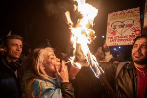 A female protester light up a cigarette from the burning poster with the Supreme Leader of Iran, Ayatollah Ali Khamenei on it during the demonstration outside the Iranian Embassy in London. Hundreds of Iranian royalists gathered outside the Iranian Embassy in London, UK. Protesters want to show their support to the anti-government protesters in Iran. Demonstrators intend to replace the Supreme Leader of Iran, Ayatollah Ali Khamenei, and his regime with the Crown Prince of Iran, Reza Pahlavi who lives in exile at the United States.