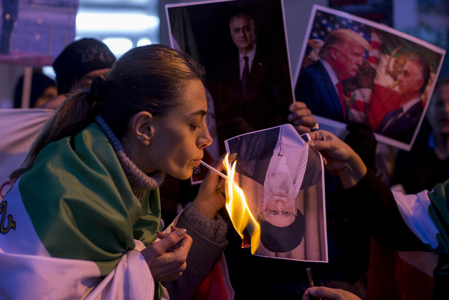 A protester lights a cigarette by the flame of a poster with the portrait of Ali Khamenei, Supreme Leader of Iran, during a demonstration in front of the United States Embassy in Madrid. Iranian community in Madrid stage a demonstration demanding an end to the violence and repression by the Islamic Republic regime across Iran.