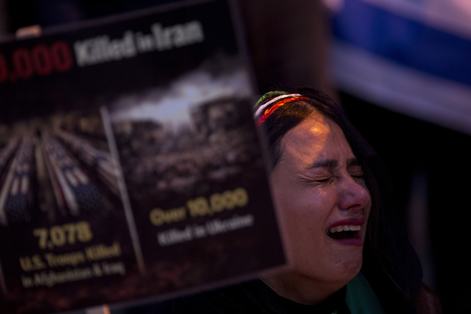 A protester cries while holding a sign during a demonstration in front of the United States Embassy in Madrid. Iranian community in Madrid stage a demonstration demanding an end to the violence and repression by the Islamic Republic regime across Iran.