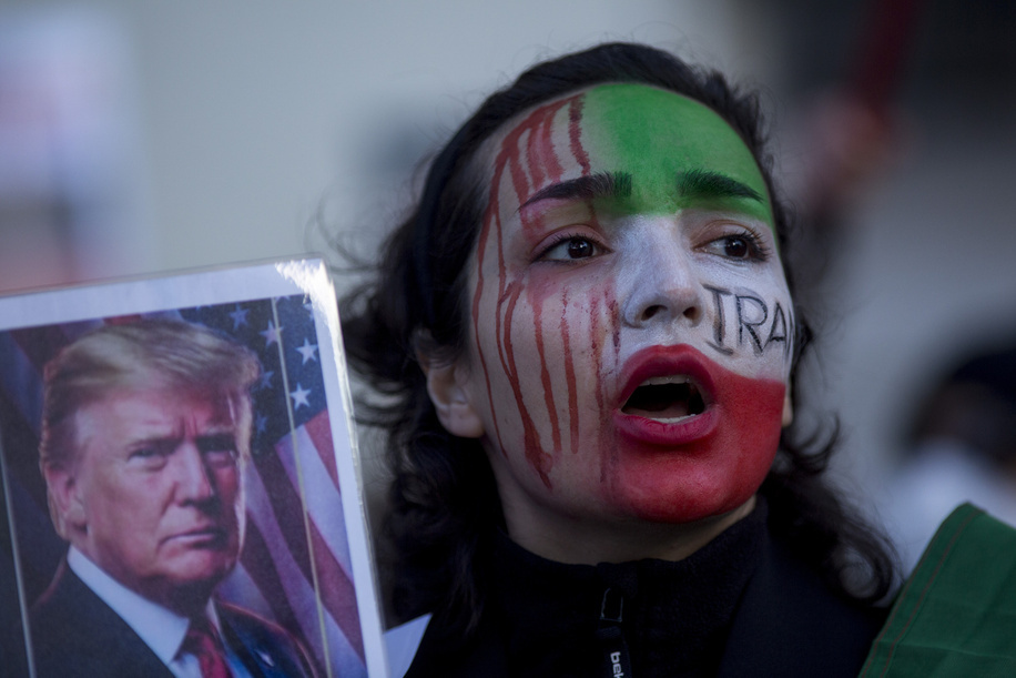 A protester with her face painted with the Iranian flag, chants while holding poster of Donald Trump during a demonstration in front of the United States Embassy in Madrid. Iranian community in Madrid stage a demonstration demanding an end to the violence and repression by the Islamic Republic regime across Iran.