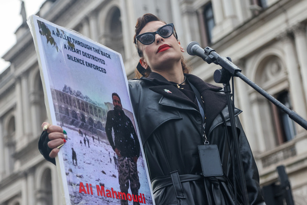 Lily Moo (often identified as ÊElaaheh Jamali) is a London-based Iranian human rights activist and feminist holds a placard during a rally outside Downing Street in London, calling on the UK government to support human rights and proscribe the Islamic Revolutionary Guard Corps (IRGC).