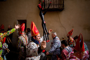 A member of the Endiablada brotherhood carries in his hand a club and a scepter in the shape of a devil, during the festival of La Endiablada in Almonacid del Marquesado. Celebrated in honor of the Virgin of Candelaria and Saint Blaise of Sebaste, La Endiablada is considered one of Spain’s oldest traditional festivals. During the event, men known as “the Devils,” dressed in colorful costumes with cowbells around their waists, jump and dance through the streets while carrying the statue of the saint in a lively procession.