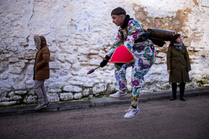 A member of the Endiablada brotherhood, wearing cowbells on his waist and the traditional costume, jumps with his arms in the procession of the image of Saint Blaise, during the festival of La Endiablada in Almonacid del Marquesado. Celebrated in honor of the Virgin of Candelaria and Saint Blaise of Sebaste, La Endiablada is considered one of Spain’s oldest traditional festivals. During the event, men known as “the Devils,” dressed in colorful costumes with cowbells around their waists, jump and dance through the streets while carrying the statue of the saint in a lively procession.