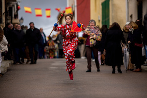 A member of the Endiablada brotherhood, wearing cowbells on his waist and the traditional costume, jumps with his arms in the procession of the image of Saint Blaise, during the festival of La Endiablada in Almonacid del Marquesado. Celebrated in honor of the Virgin of Candelaria and Saint Blaise of Sebaste, La Endiablada is considered one of Spain’s oldest traditional festivals. During the event, men known as “the Devils,” dressed in colorful costumes with cowbells around their waists, jump and dance through the streets while carrying the statue of the saint in a lively procession.