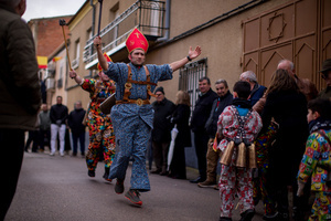 Members of the Endiablada brotherhood jump with open arms in front of the procession of the image of Saint Blaise, during the festival of La Endiablada in Almonacid del Marquesado. Celebrated in honor of the Virgin of Candelaria and Saint Blaise of Sebaste, La Endiablada is considered one of Spain’s oldest traditional festivals. During the event, men known as “the Devils,” dressed in colorful costumes with cowbells around their waists, jump and dance through the streets while carrying the statue of the saint in a lively procession.