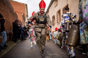 A member of the Endiablada brotherhood, wearing cowbells on his waist and the traditional costume, jumps with his arms in the procession of the image of Saint Blaise, during the festival of La Endiablada in Almonacid del Marquesado. Celebrated in honor of the Virgin of Candelaria and Saint Blaise of Sebaste, La Endiablada is considered one of Spain’s oldest traditional festivals. During the event, men known as “the Devils,” dressed in colorful costumes with cowbells around their waists, jump and dance through the streets while carrying the statue of the saint in a lively procession.
