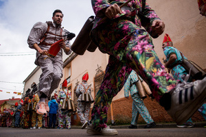 A member of the Endiablada brotherhood, wearing cowbells on his waist and the traditional costume, jumps with his arms in the procession of the image of Saint Blaise, during the festival of La Endiablada in Almonacid del Marquesado. Celebrated in honor of the Virgin of Candelaria and Saint Blaise of Sebaste, La Endiablada is considered one of Spain’s oldest traditional festivals. During the event, men known as “the Devils,” dressed in colorful costumes with cowbells around their waists, jump and dance through the streets while carrying the statue of the saint in a lively procession.