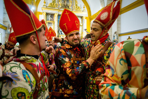 Members of the Endiablada brotherhood embrace after the procession of the image of Saint Blaise, during the festival of La Endiablada in Almonacid del Marquesado. Celebrated in honor of the Virgin of Candelaria and Saint Blaise of Sebaste, La Endiablada is considered one of Spain’s oldest traditional festivals. During the event, men known as “the Devils,” dressed in colorful costumes with cowbells around their waists, jump and dance through the streets while carrying the statue of the saint in a lively procession.