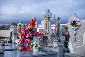A member of the Endiablada brotherhood prays beside a relative's grave in the town cemetery, during the festival of La Endiablada in Almonacid del Marquesado. Celebrated in honor of the Virgin of Candelaria and Saint Blaise of Sebaste, La Endiablada is considered one of Spain’s oldest traditional festivals. During the event, men known as “the Devils,” dressed in colorful costumes with cowbells around their waists, jump and dance through the streets while carrying the statue of the saint in a lively procession.