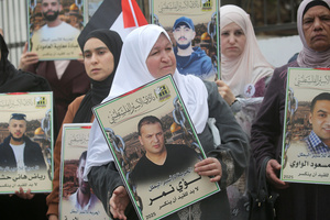Mothers of Palestinian prisoners seen holding up pictures of their sons during the solidarity vigil in front of the International Committee of the Red Cross in Nablus, West Bank. The vigil also served as a protest against the death penalty law approved by the Israeli cabinet.