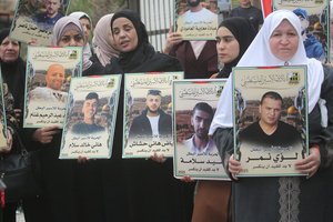 Mothers of Palestinian prisoners seen holding up pictures of their sons during the solidarity vigil in front of the International Committee of the Red Cross in Nablus, West Bank. The vigil also served as a protest against the death penalty law approved by the Israeli cabinet.