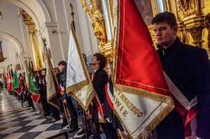 Congregants hold flags during the Mass for the fallen. On the afternoon of the 14th of February, Poland celebrates the National Day of Remembrance of the Home Army Soldiers, a state holiday commemorating the Polish underground militias during World War II. After a Mass for the fallen at the Basilica of the Holy Cross, a Parade of Respect passes through the streets of Warsaw in the direction of the Monument to the Polish Underground State and the Home Army at the Polish Parliament, where a wreath-laying ceremony takes place.