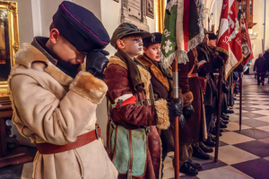 Boys in period dress hold flags during the mass for the fallen. On the afternoon of the 14th of February, Poland celebrates the National Day of Remembrance of the Home Army Soldiers, a state holiday commemorating the Polish underground militias during World War II. After a Mass for the fallen at the Basilica of the Holy Cross, a Parade of Respect passes through the streets of Warsaw in the direction of the Monument to the Polish Underground State and the Home Army at the Polish Parliament, where a wreath-laying ceremony takes place.