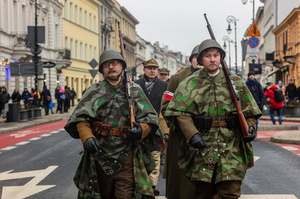 Historical reenactors in period military dress march in the parade. On the afternoon of the 14th of February, Poland celebrates the National Day of Remembrance of the Home Army Soldiers, a state holiday commemorating the Polish underground militias during World War II. After a Mass for the fallen at the Basilica of the Holy Cross, a Parade of Respect passes through the streets of Warsaw in the direction of the Monument to the Polish Underground State and the Home Army at the Polish Parliament, where a wreath-laying ceremony takes place.