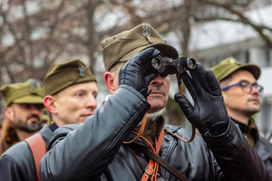 A historical reenactor in period military dress looks through binoculars. On the afternoon of the 14th of February, Poland celebrates the National Day of Remembrance of the Home Army Soldiers, a state holiday commemorating the Polish underground militias during World War II. After a Mass for the fallen at the Basilica of the Holy Cross, a Parade of Respect passes through the streets of Warsaw in the direction of the Monument to the Polish Underground State and the Home Army at the Polish Parliament, where a wreath-laying ceremony takes place.
