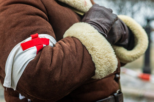 A period-accurate first aid armband is seen during the parade. On the afternoon of the 14th of February, Poland celebrates the National Day of Remembrance of the Home Army Soldiers, a state holiday commemorating the Polish underground militias during World War II. After a Mass for the fallen at the Basilica of the Holy Cross, a Parade of Respect passes through the streets of Warsaw in the direction of the Monument to the Polish Underground State and the Home Army at the Polish Parliament, where a wreath-laying ceremony takes place.