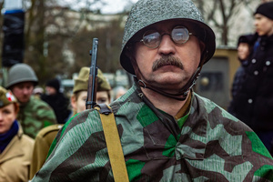 A historical reenactor in period military dress is seen during the ceremony. On the afternoon of the 14th of February, Poland celebrates the National Day of Remembrance of the Home Army Soldiers, a state holiday commemorating the Polish underground militias during World War II. After a Mass for the fallen at the Basilica of the Holy Cross, a Parade of Respect passes through the streets of Warsaw in the direction of the Monument to the Polish Underground State and the Home Army at the Polish Parliament, where a wreath-laying ceremony takes place.