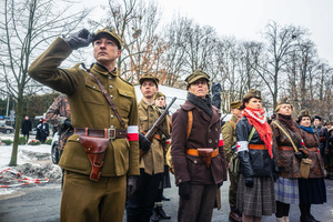 A historical reenactor in period military dress salutes during the ceremony. On the afternoon of the 14th of February, Poland celebrates the National Day of Remembrance of the Home Army Soldiers, a state holiday commemorating the Polish underground militias during World War II. After a Mass for the fallen at the Basilica of the Holy Cross, a Parade of Respect passes through the streets of Warsaw in the direction of the Monument to the Polish Underground State and the Home Army at the Polish Parliament, where a wreath-laying ceremony takes place.