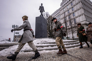Historical reenactors march in front of a statue of French General Charles de Gaulle. On the afternoon of the 14th of February, Poland celebrates the National Day of Remembrance of the Home Army Soldiers, a state holiday commemorating the Polish underground militias during World War II. After a Mass for the fallen at the Basilica of the Holy Cross, a Parade of Respect passes through the streets of Warsaw in the direction of the Monument to the Polish Underground State and the Home Army at the Polish Parliament, where a wreath-laying ceremony takes place.