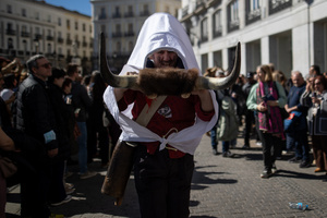 A man dressed in white pushes a horned contraption during the 1st Masquerade Parade through the center of Madrid, organized by the regional associations of Asturias, Galicia, and Zamora, the heart of the Spanish capital was transformed into a stage for ancestral rites from the Spanish regions of Asturias, Galicia, and Zamora.