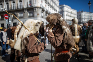 A couple dressed in fur coats is seen. during the 1st Masquerade Parade through the center of Madrid, organized by the regional associations of Asturias, Galicia, and Zamora, the heart of the Spanish capital was transformed into a stage for ancestral rites from the Spanish regions of Asturias, Galicia, and Zamora.