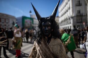 A woman with her face painted black and wearing horns is seen. during the 1st Masquerade Parade through the center of Madrid, organized by the regional associations of Asturias, Galicia, and Zamora, the heart of the Spanish capital was transformed into a stage for ancestral rites from the Spanish regions of Asturias, Galicia, and Zamora.