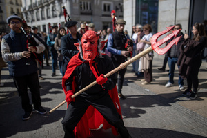A man dressed as a red demon is seen. during the 1st Masquerade Parade through the center of Madrid, organized by the regional associations of Asturias, Galicia, and Zamora, the heart of the Spanish capital was transformed into a stage for ancestral rites from the Spanish regions of Asturias, Galicia, and Zamora.
