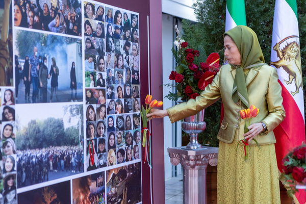 Maryam Rajavi places flowers before a memorial wall featuring images of women victims of repression, paying tribute to the pioneering women who laid down their lives for Iran’s freedom. Iranian opposition figures and international delegates gathered for an International Women’s Day 2026 conference to emphasize women’s leadership as the central pillar of democratic transition in Iran. Speakers endorsed the NCRI Ten-Point Plan, highlighted the role of women-led Resistance Units, and rejected both clerical rule and any return to monarchy, framing women’s political leadership as the litmus test for a future secular and democratic republic.