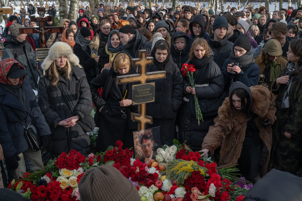 People attend the funeral of Nikolai Komyagin, lead singer of the band Shortparis, at Smolensky Cemetery in Saint Petersburg.