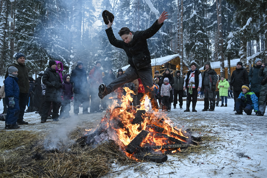 A man jumps over a bonfire left after the burning of an effigy during celebrations of Maslenitsa (Shrovetide), a traditional Russian folk festival marking the end of winter, at Emerald Lake in the village of Toksovo in the Leningrad region.